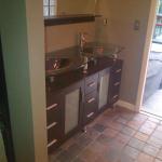 CUSTOM GLASS TOP VANITY OPEN WITH RECESS LIGHTS ABOVE