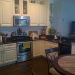 CUSTOM 42" CABINETS WITH SOFFITS REMOVED AND NEW HARDWOOD COFFEE FLOORS IN COASTAL CREAM WITH BROWN ANTIQUE GRANITE