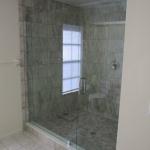 CUSTOM SHOWER  USED TO BE A OLD BATH TUB WITH CUSTOM FRAMELESS GLASS