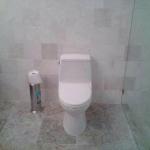 TOTO TOILET WITH TILE WALLS AND FLOOR IN MARBLE