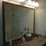 VANITY WITH SLAB MIRROR ,CUSTOM TRIM AROUND AND TWO LIGHT FIXTURES