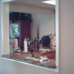 WALL AFTER DEMO AND NEW OPENING MADE CASED WITH TRIM AND GRANITE