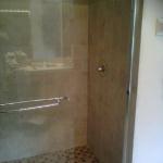 SHOWER WITH DELTA VALVE IN CHROME AND KOHLER GLASS SHOWER DOOR IN CHROME.