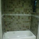 3X3 PORCELAIN SLATE TILE WITH MOSAIC BORDER. BRIGGS WHITE ENAMEL STEEL TUB WITH PRICE PHISTER VALVE IN  SATIN NICKEL